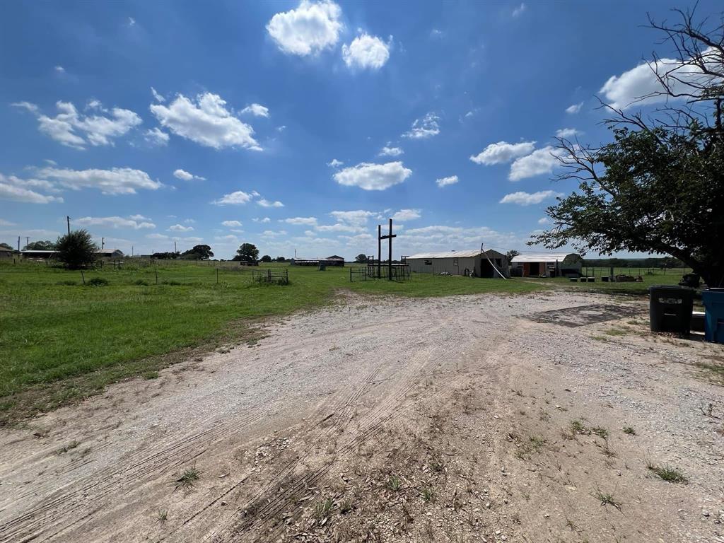 306 Grindstone Road Weatherford, TX 76087 - Photo 18 of 18 a view of a yard with wooden fence