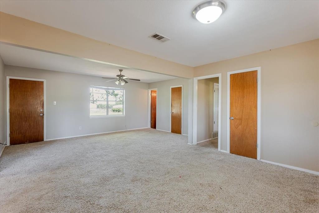 306 Grindstone Road Weatherford, TX 76087 - Photo 2 of 18 an empty room with windows and closet
