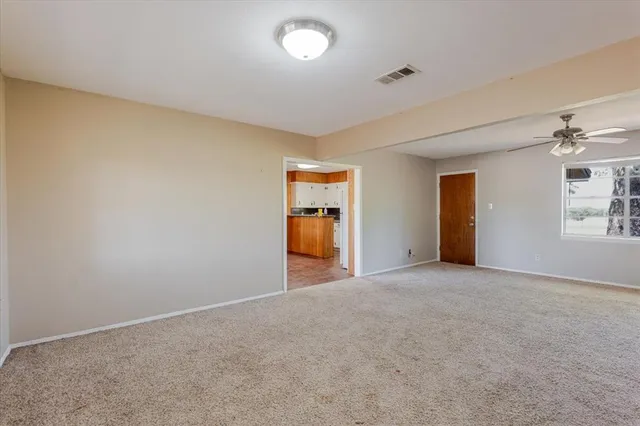 a view of empty room with a fireplace