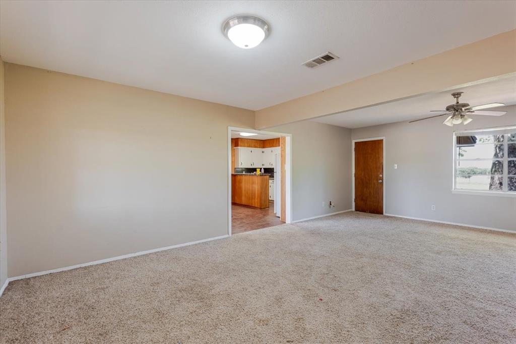 306 Grindstone Road Weatherford, TX 76087 - Photo 3 of 18 a view of empty room with a fireplace