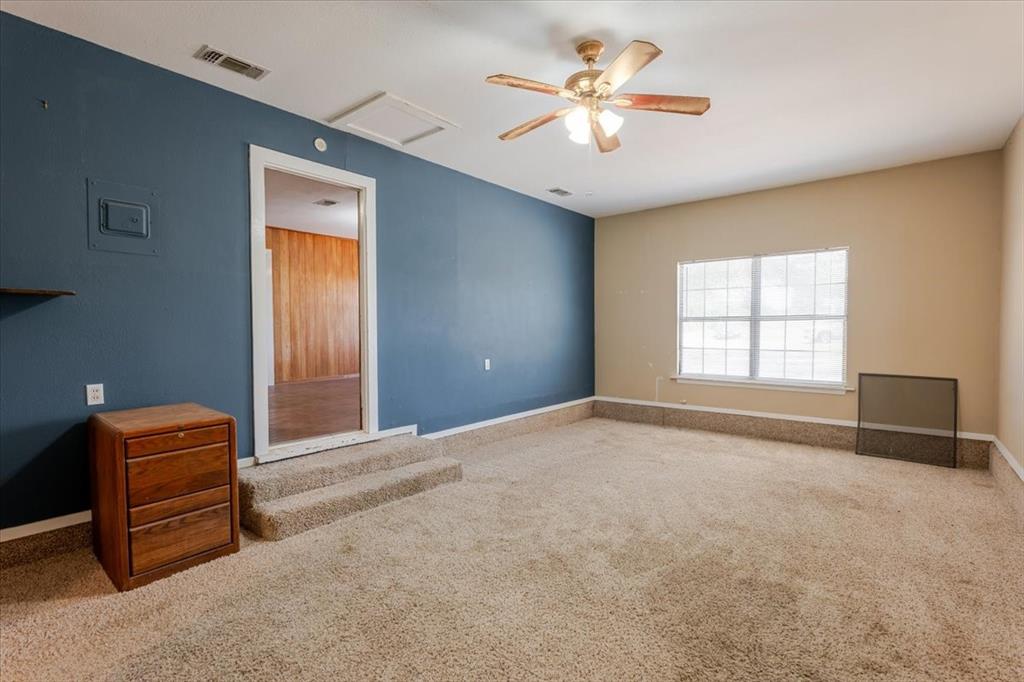 306 Grindstone Road Weatherford, TX 76087 - Photo 10 of 18 an empty room with windows and ceiling fan
