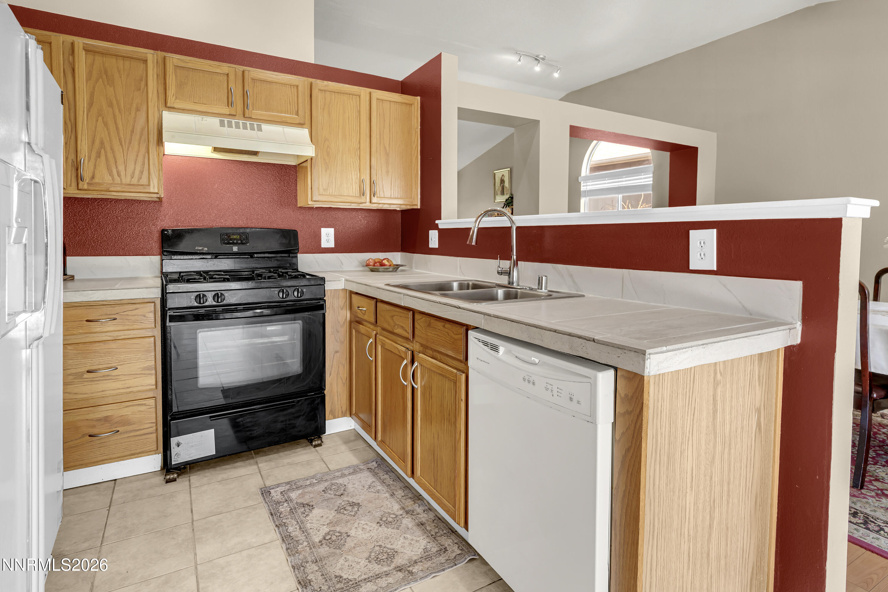 7951 Big River Drive Reno, NV 89506 - Photo 12 of 30 a kitchen with a stove cabinets and a sink