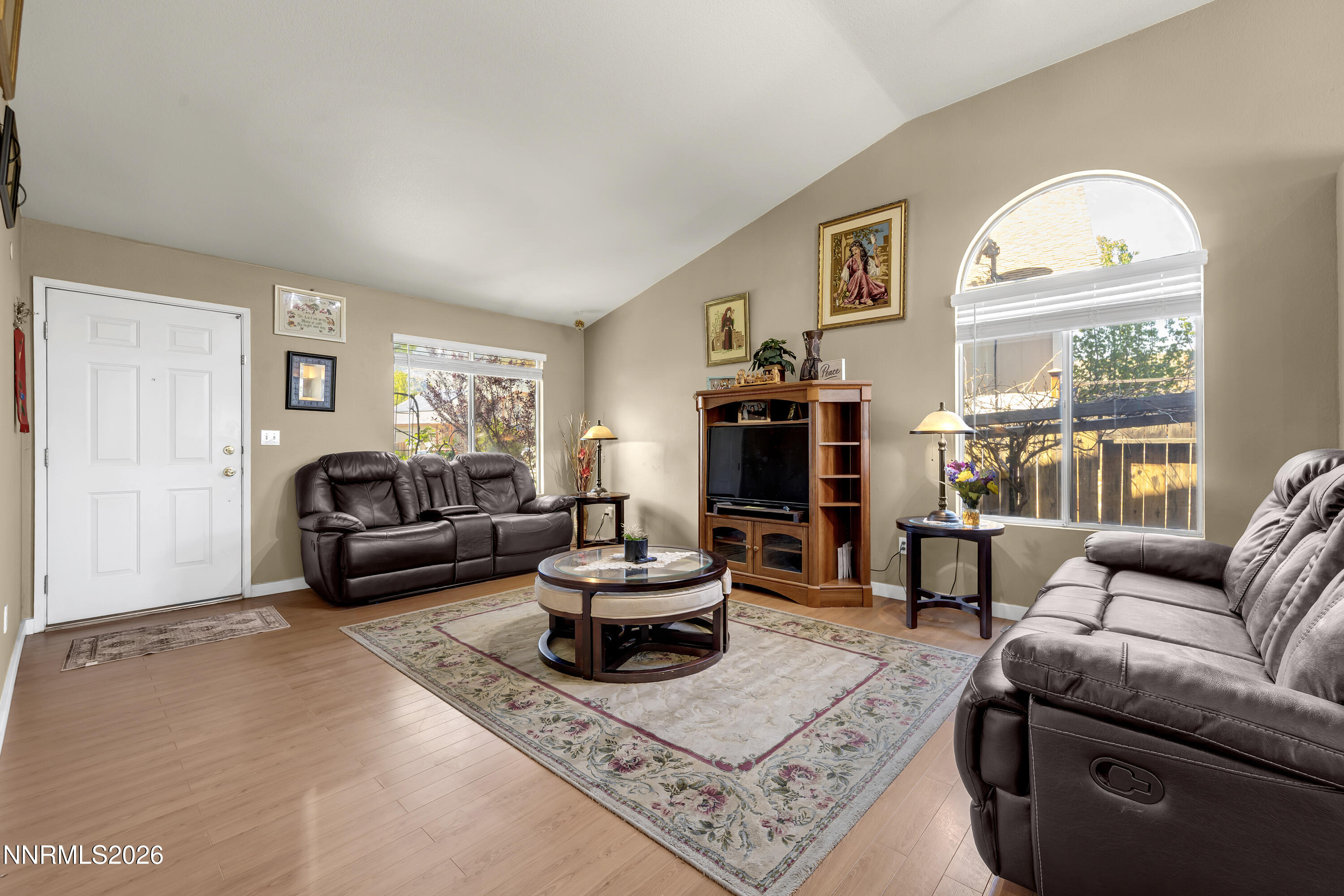 7951 Big River Drive Reno, NV 89506 - Photo 4 of 30 a living room with furniture a rug a fireplace and a large window