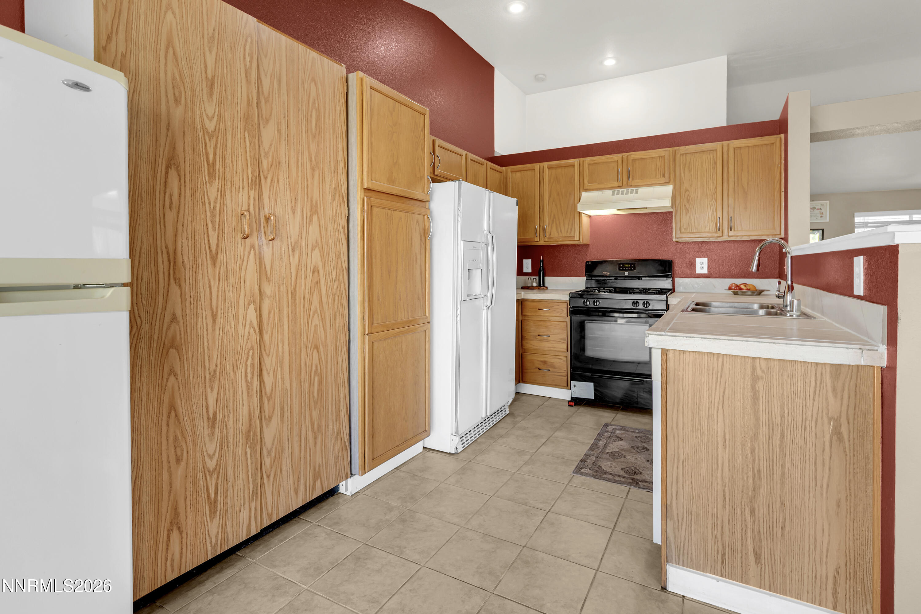 7951 Big River Drive Reno, NV 89506 - Photo 10 of 30 a kitchen with a refrigerator a stove top oven