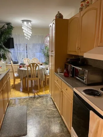 a kitchen with refrigerator and cabinets