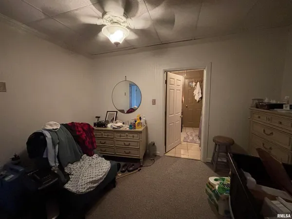 a living room with furniture and a mirror