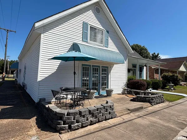 a front view of a house with sitting area