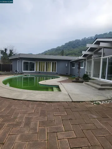 a view of a backyard with sitting area