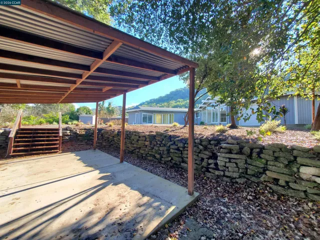 a view of a backyard with sitting area