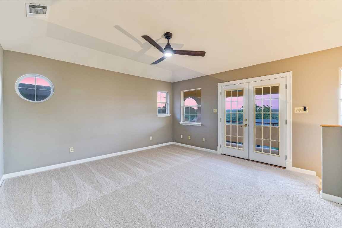 2405 Bahama Road Austin, TX 78733 - Photo 16 of 38 Carpeted empty room featuring french doors and ceiling fan