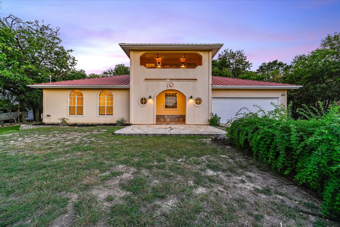 2405 Bahama Road Austin, TX 78733 - Photo 18 of 38 Mediterranean / spanish home with a metal roof, an attached garage, a front yard, and stucco siding