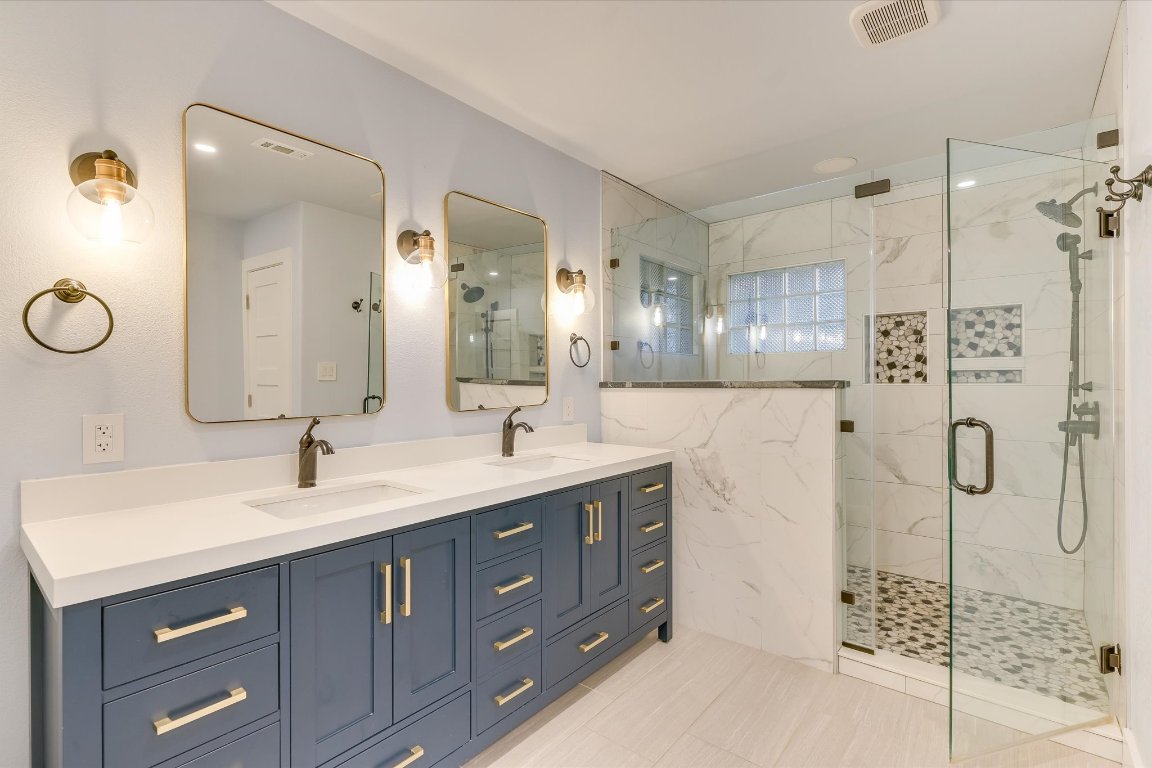 2405 Bahama Road Austin, TX 78733 - Photo 3 of 38 Updated bathroom featuring a marble finish shower and double vanity