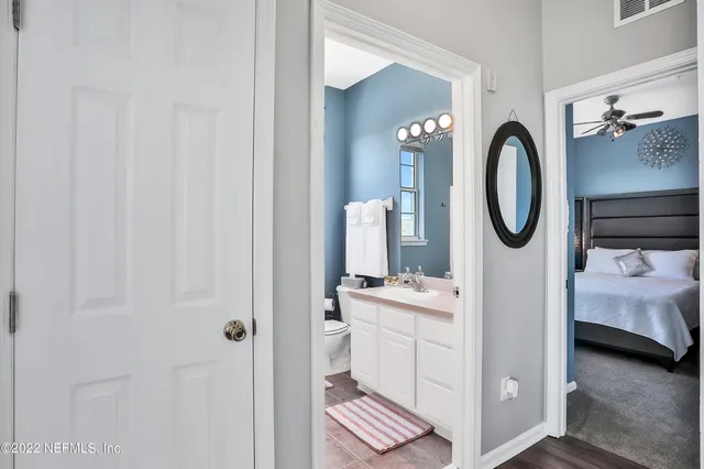 a bathroom with a sink a mirror and a toilet