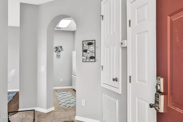 wooden floor with white walls and stairs
