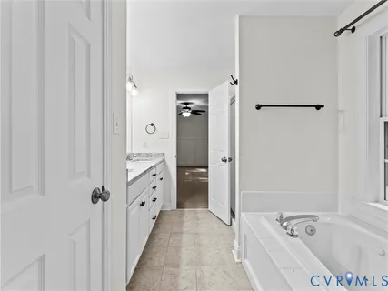 a white bath tub sitting next to a window