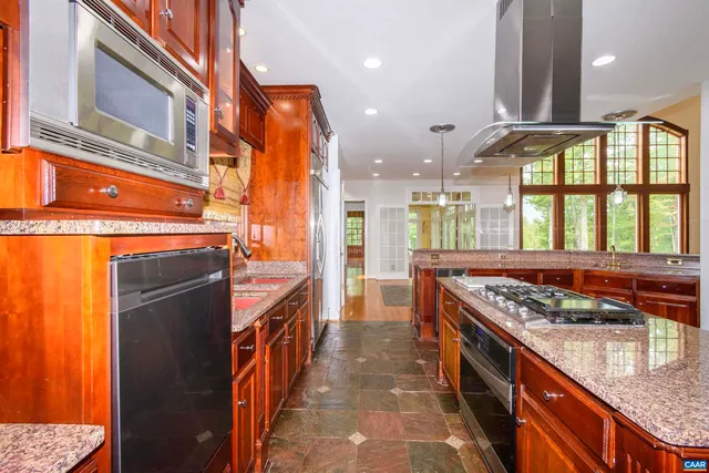 a kitchen with stainless steel appliances granite countertop a stove and a sink