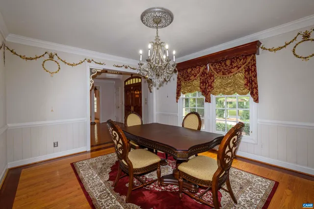 a view of empty room with window and wooden floor