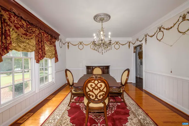 a spacious bedroom with a large bed and a chandelier