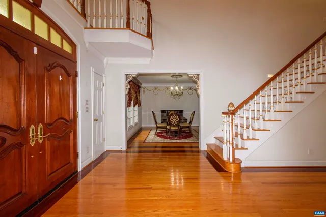 a spacious bathroom with a granite countertop sink a mirror and a bathtub