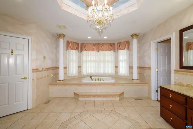 a bathroom with a granite countertop sink and a toilet