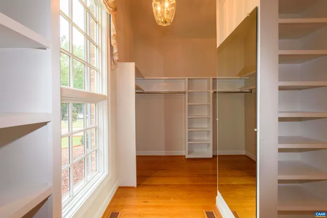 a bathroom with a granite countertop sink vanity mirror and a bathtub