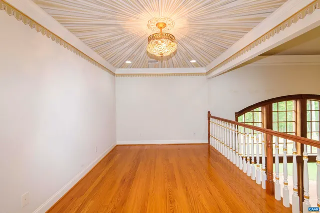 a view of a room with wooden floor and staircase