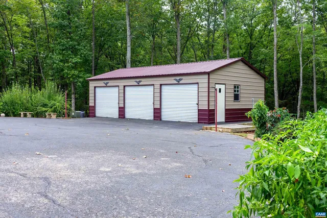 a living room with fireplace furniture and a large window