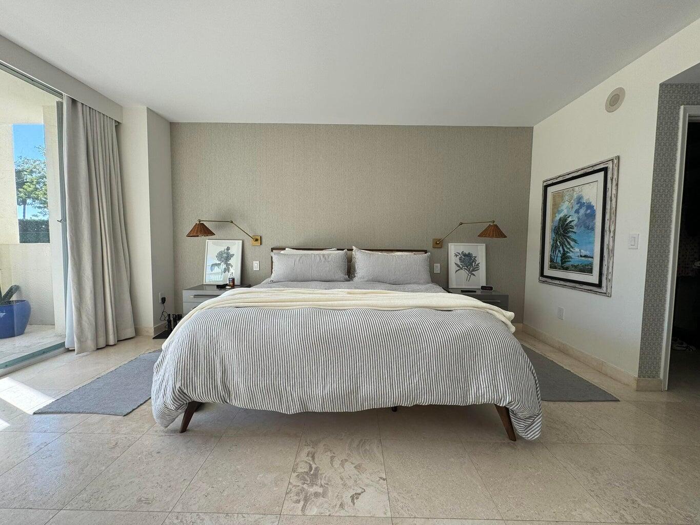 3400 Southwest 27th Avenue, Unit 303 Miami, FL 33133 - Photo 8 of 12 a bedroom with a bed and painting on the wall