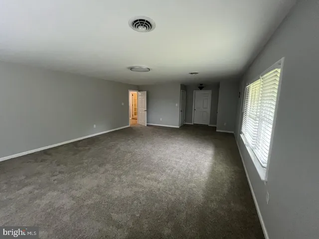 an empty room with windows and entrance