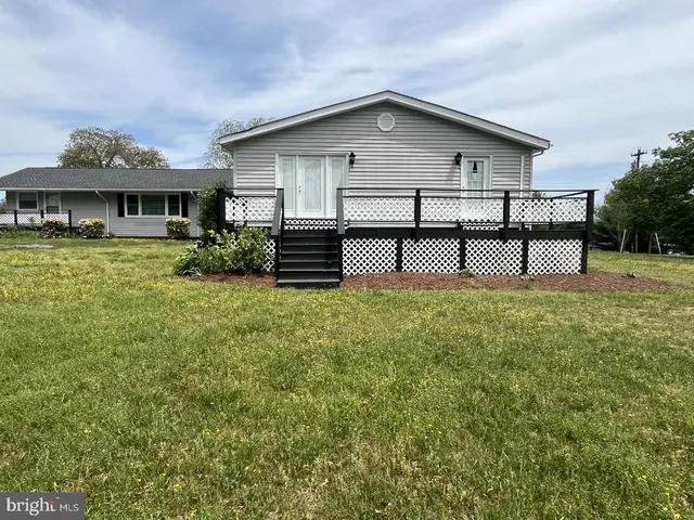 a view of a house with a yard and sitting area