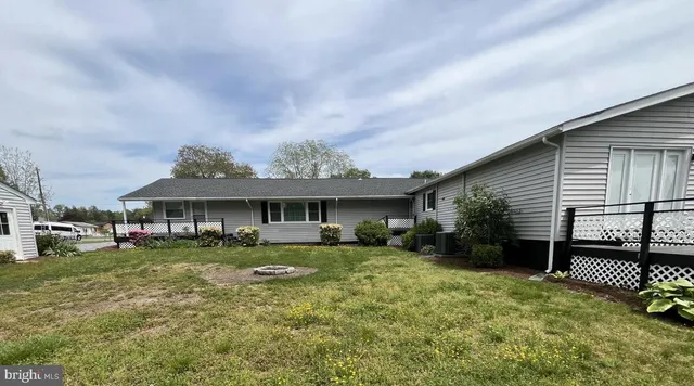 a view of a house with a yard and deck