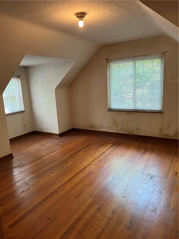 1023 Wetzel Road Pittsburgh, PA 15209 - Photo 4 of 11 an empty room with wooden floor and windows