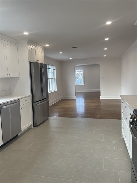 29 Crescent Road, Unit 29 Belmont, MA 02478 - Photo 8 of 21 a view of a kitchen with refrigerator and white cabinets