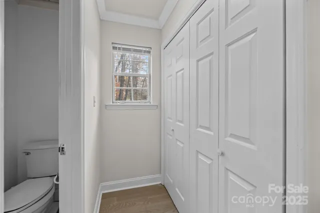 a bedroom with a bed table and flat screen tv