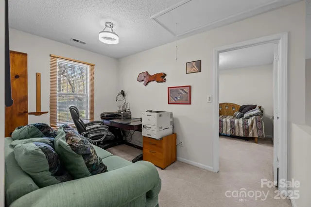 a bedroom with beds and a chandelier