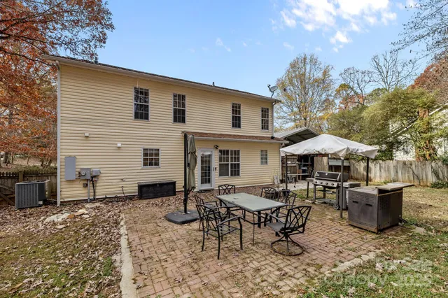 a backyard of a house with yard fire pit and outdoor seating