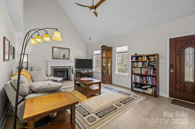 a living room with fireplace furniture and a book shelf
