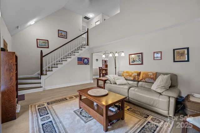 a living room with furniture and a chandelier