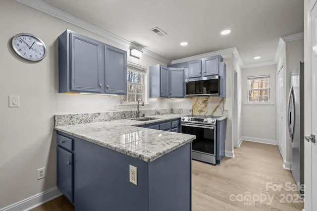 a kitchen with a stove a sink and a refrigerator