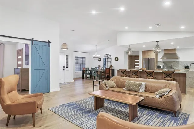 a large kitchen with a table and chairs