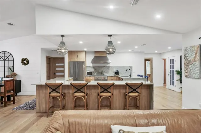 a kitchen with stainless steel appliances granite countertop a sink and a stove