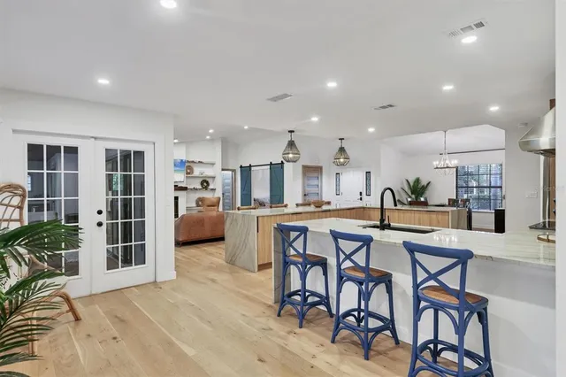 a kitchen with stainless steel appliances granite countertop sink stove and refrigerator
