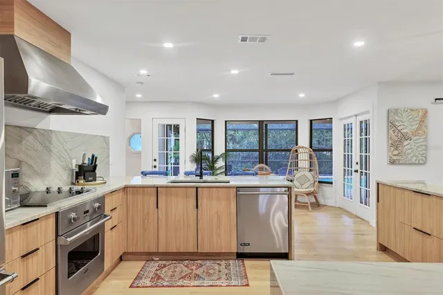 a view of a dining room with furniture and chandelier