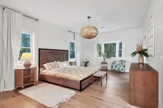 a bedroom with a large bed and a flat screen tv