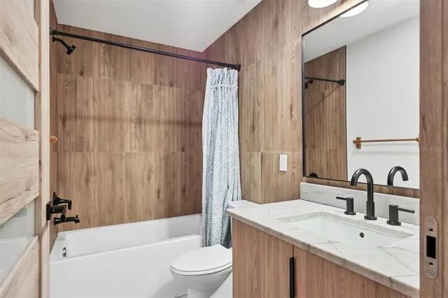 a wooden house with trees in front of it