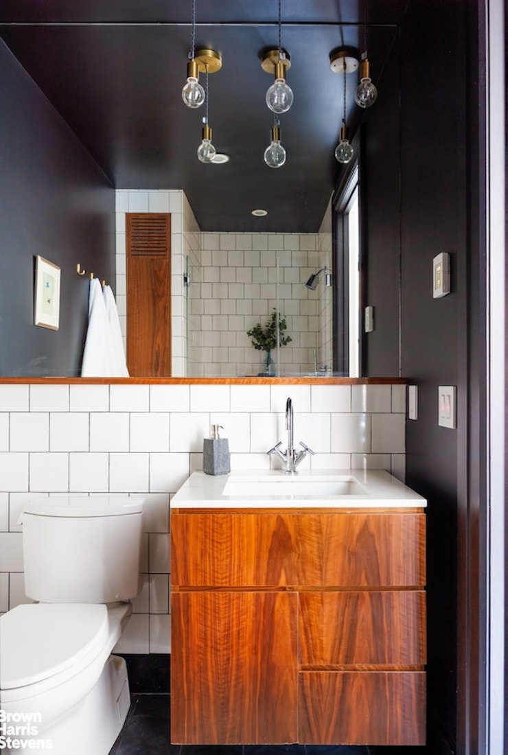 1 Main Street, Unit 5H Brooklyn, NY 11201 - Photo 10 of 14 a bathroom with a sink vanity mirror and toilet