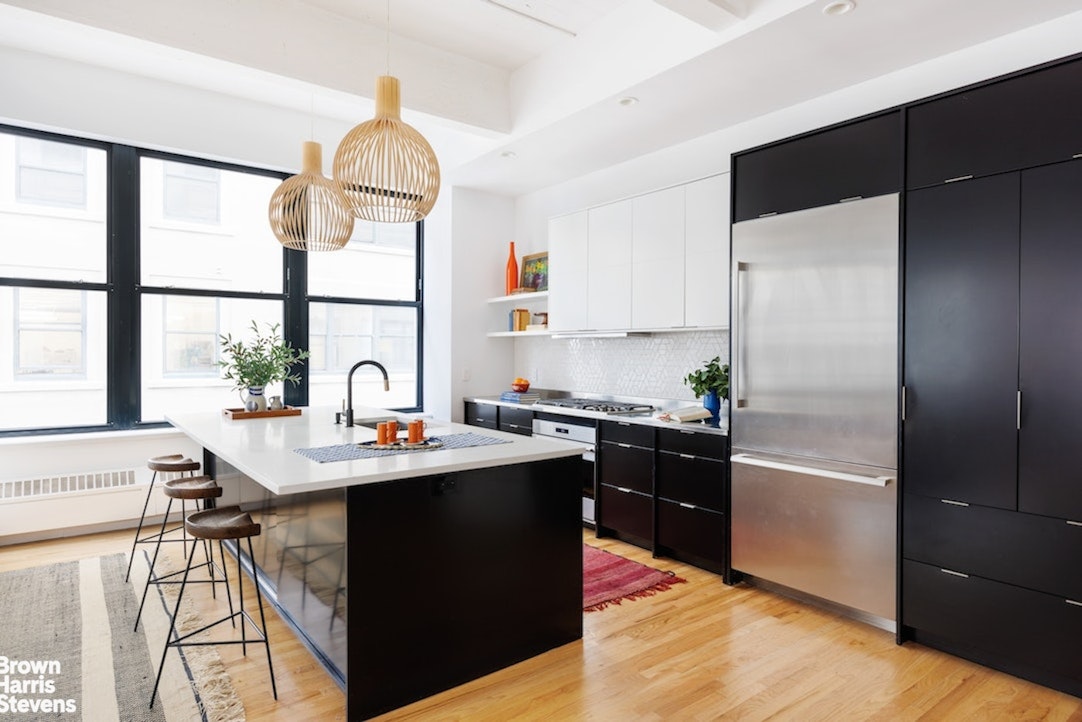 1 Main Street, Unit 5H Brooklyn, NY 11201 - Photo 2 of 17 a kitchen with stainless steel appliances kitchen island granite countertop a sink refrigerator and cabinets