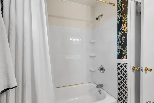 a bathroom with a bathtub and shower