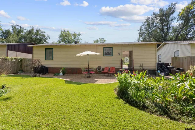 a view of a backyard with plants and a patio