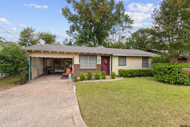 a view of a house with a backyard and a garage